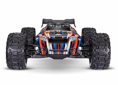 Front view of a colorful remote control monster truck with large tires.