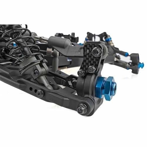 Close-up of an RC car suspension system with blue anodized components.