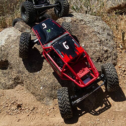 RC rock crawler climbing over large boulders