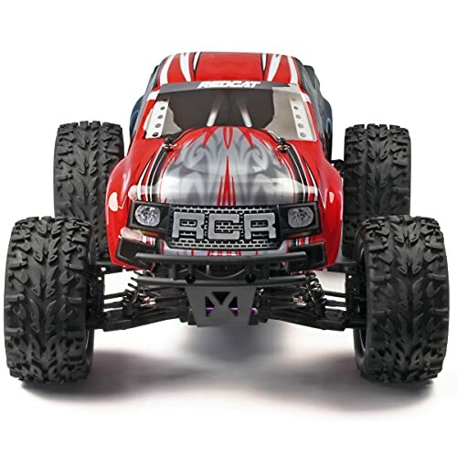 Red RC monster truck with large tires.