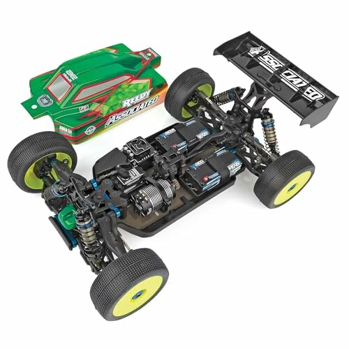 Remote control car chassis with exposed components and green body shell.